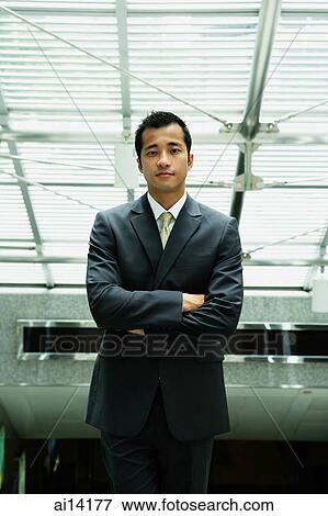 Businessman with arms crossed, looking at camera View Large Photo Image Stock Photo - Businessman with arms crossed, looking at camera. Fotosearch