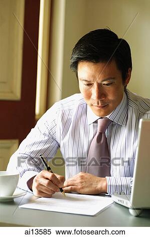 Stock Photography - Businessman writing on paper. Fotosearch
