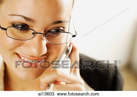 Stock Image - Businesswoman using mobile phone. Fotosearch