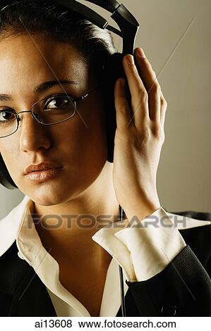 Businesswoman wearing headphones View Large Photo Image Stock Photo - Businesswoman wearing headphones. Fotosearch