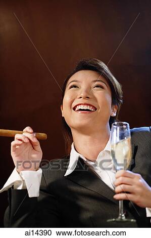 Businesswoman with glass of champagne and cigar, looking up, View Large Photo Image Stock Image - Businesswoman with glass of champagne and cigar, looking up,. Fotosearch