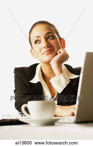 Businesswoman with laptop open, hand on chin View Large Photo Image Stock Image - Businesswoman with laptop open, hand on chin. Fotosearch