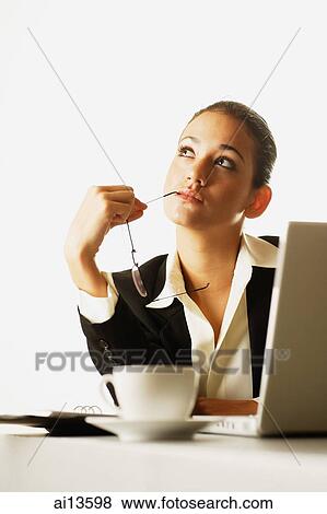 Businesswoman with laptop open, holding glasses View Large Photo Image Stock Photo - Businesswoman with laptop open, holding glasses. Fotosearch