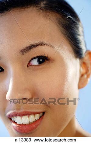 Stock Photo -  Close up of woman's face, looking away. Fotosearch