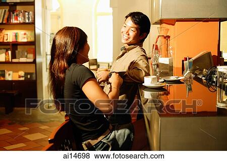 Couple at bar counter, talking View Large Photo Image Stock Photo - Couple at bar counter, talking. Fotosearch