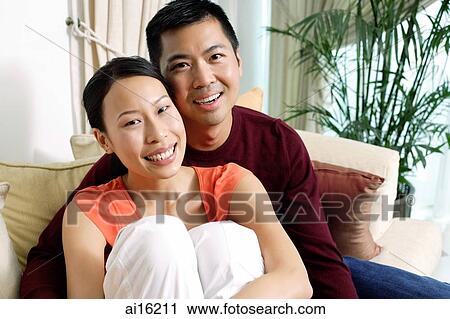 Couple at home, looking at camera View Large Photo Image Stock Image - Couple at home, looking at camera. Fotosearch