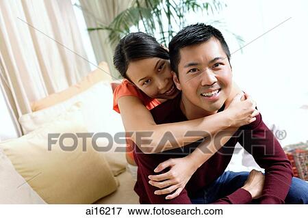 Couple at home, woman embracing man View Large Photo Image Stock Photo - Couple at home, woman embracing man. Fotosearch