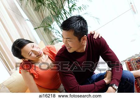 Couple at home, woman with arm on mans shoulder View Large Photo Image Stock Photo - Couple at home, woman with arm on mans shoulder. Fotosearch