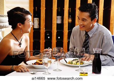 Stock Photography - Couple eating in restaurant. Fotosearch