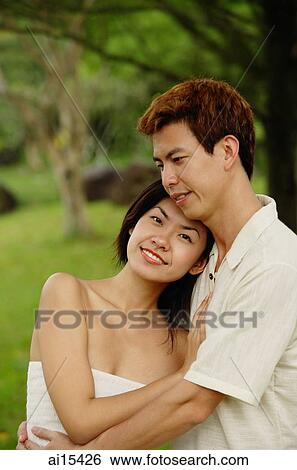 Couple embracing, woman looking at camera View Large Photo Image Stock Photograph - Couple embracing, woman looking at camera. Fotosearch