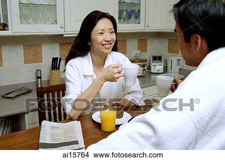 Couple having breakfast, drinking coffee View Large Photo Image Picture - Couple having breakfast, drinking coffee. Fotosearch