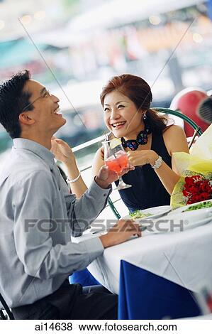 Couple having lunch, laughing View Large Photo Image Stock Photo - Couple having lunch, laughing. Fotosearch