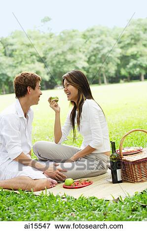 Couple having picnic in park View Large Photo Image Stock Photo - Couple having picnic in park. Fotosearch