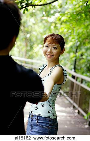 Couple holding hands, woman facing camera View Large Photo Image Stock Image - Couple holding hands, woman facing camera. Fotosearch