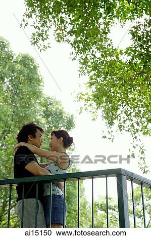 Couple hugging and looking at each other, outdoor location View Large Photo Image Stock Image - Couple hugging and looking at each other, outdoor location. Fotosearch