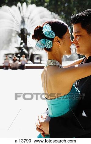 Couple hugging face to face, water fountain behind them View Large Photo Image Stock Image - Couple hugging face to face, water fountain behind them. Fotosearch