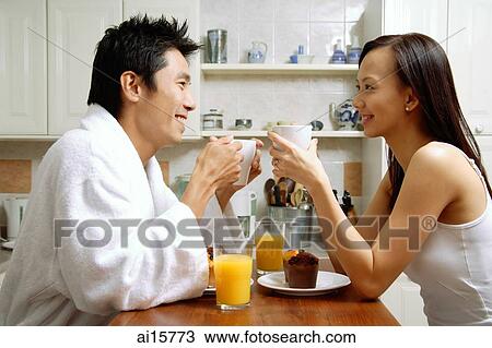 Couple in kitchen, having breakfast View Large Photo Image Stock Image - Couple in kitchen, having breakfast. Fotosearch