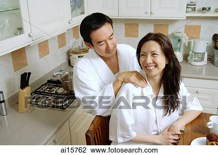 Couple in kitchen, man massaging womans shoulder View Large Photo Image Stock Image - Couple in kitchen, man massaging womans shoulder. Fotosearch