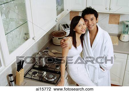 Couple in kitchen, smiling at camera View Large Photo Image Stock Image - Couple in kitchen, smiling at camera. Fotosearch