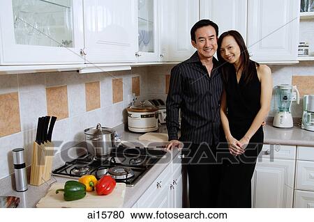 Couple in kitchen, smiling at camera View Large Photo Image Stock Image - Couple in kitchen, smiling at camera. Fotosearch