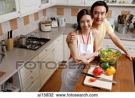 Couple in kitchen, smiling at camera, portrait View Large Photo Image Stock Image - Couple in kitchen, smiling at camera, portrait. Fotosearch