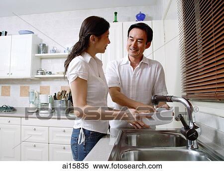 Couple in kitchen, washing dishes View Large Photo Image Stock Photography - Couple in kitchen, washing dishes. Fotosearch
