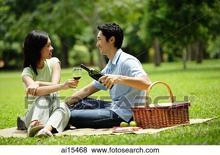 Couple in park, man pouring wine for woman, portrait View Large Photo Image Stock Photo - Couple in park, man pouring wine for woman, portrait. Fotosearch