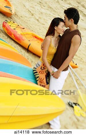 Couple on beach, man kissing woman's forehead View Large Photo Image Stock Photo - Couple on beach, man kissing woman's forehead. Fotosearch