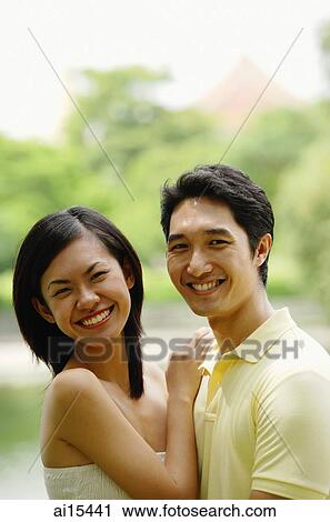 Stock Image - Couple smiling at camera. Fotosearch