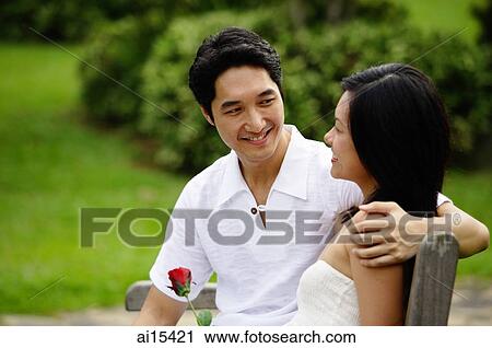 Stock Image - Couple smiling at each other. Fotosearch
