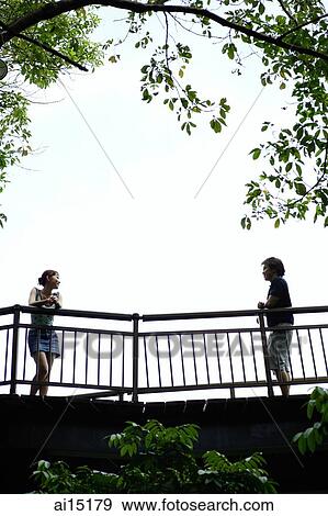Couple standing apart, looking at each other View Large Photo Image Stock Photo - Couple standing apart, looking at each other. Fotosearch