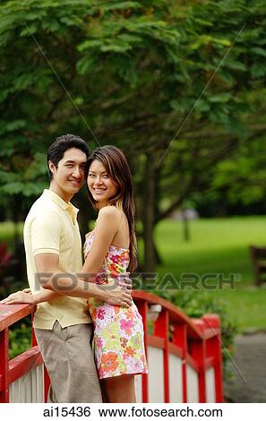 Couple standing cheek to cheek, smiling at camera View Large Photo Image Stock Photograph - Couple standing cheek to cheek, smiling at camera. Fotosearch