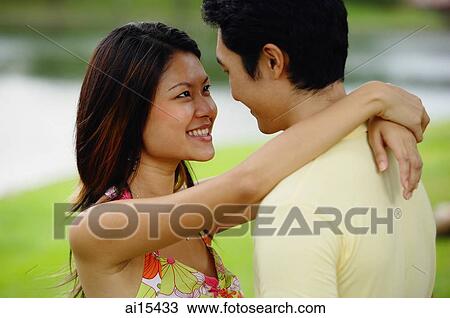 Couple standing face to face, woman with arms around man View Large Photo Image Stock Image - Couple standing face to face, woman with arms around man. Fotosearch