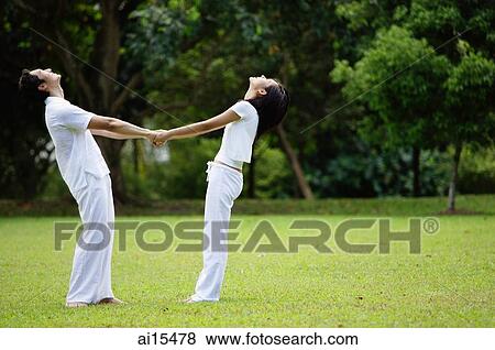 Couple standing, holding hands, looking up View Large Photo Image Stock Photo - Couple standing, holding hands, looking up. Fotosearch