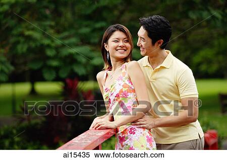 Couple standing side by side, looking at each other, portrait View Large Photo Image Stock Photography - Couple standing side by side, looking at each other, portrait. Fotosearch