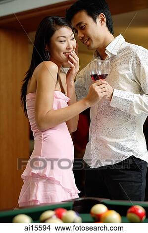 Couple standing side by side, man whispering in womans ear View Large Photo Image Picture - Couple standing side by side, man whispering in womans ear. Fotosearch