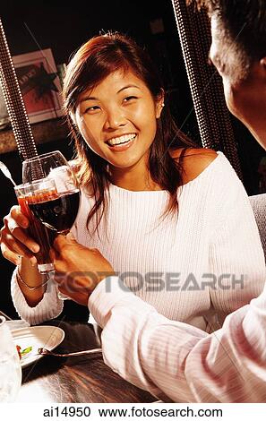 Couple toasting with drinks View Large Photo Image Stock Image - Couple toasting with drinks. Fotosearch