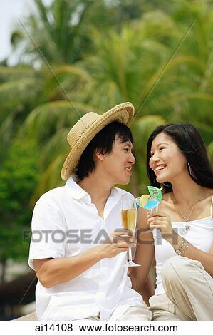 Couple toasting with drinks View Large Photo Image Stock Photo - Couple toasting with drinks. Fotosearch
