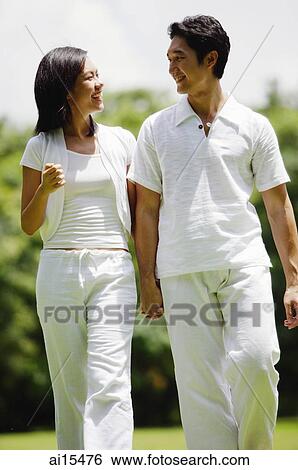 Couple walking hand in hand View Large Photo Image Stock Photograph - Couple walking hand in hand. Fotosearch