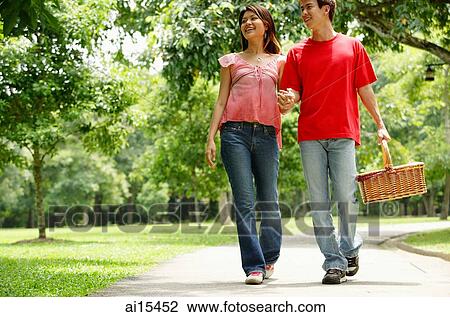 Couple walking in park, holding hands View Large Photo Image Stock Image - Couple walking in park, holding hands. Fotosearch