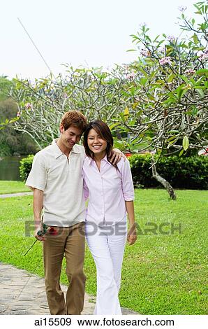 Couple walking in park View Large Photo Image Stock Photo - Couple walking in park. Fotosearch