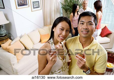 Couple with wine glasses, smiling at camera View Large Photo Image Stock Image - Couple with wine glasses, smiling at camera. Fotosearch