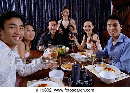 Couples at a dinner party, smiling at camera View Large Photo Image Stock Image - Couples at a dinner party, smiling at camera. Fotosearch