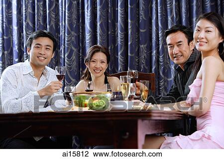 Couples having dinner at home, smiling at camera View Large Photo Image Stock Image - Couples having dinner at home, smiling at camera. Fotosearch