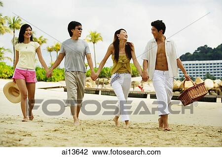Couples on beach, holding hands and walking View Large Photo Image Stock Image - Couples on beach, holding hands and walking. Fotosearch