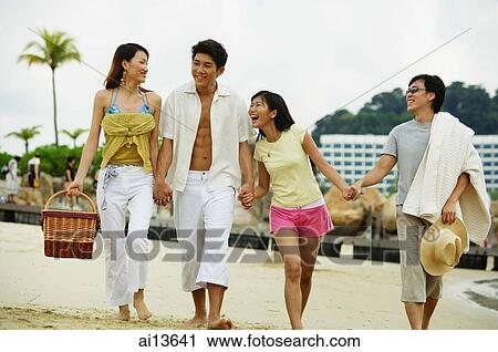 Couples on beach, walking hand in hand View Large Photo Image Stock Image - Couples on beach, walking hand in hand. Fotosearch