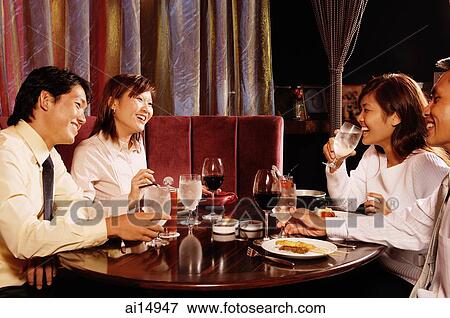 Couples sitting at restaurant, having dinner View Large Photo Image Stock Photo - Couples sitting at restaurant, having dinner. Fotosearch