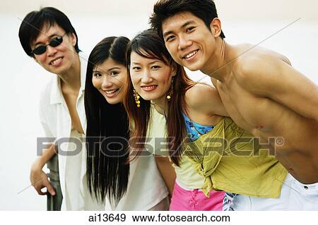 Couples standing in a row, looking at camera View Large Photo Image Stock Photo - Couples standing in a row, looking at camera. Fotosearch