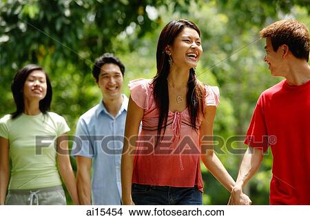 Picture - Couples walking, holding hands. Fotosearch