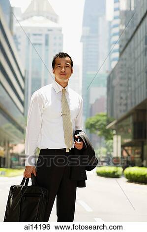 Executive carrying briefcase and jacket, looking at camera View Large Photo Image Stock Photograph - Executive carrying briefcase and jacket, looking at camera. Fotosearch